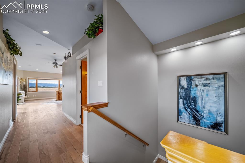 4586 East Best Road Larkspur, CO 80118 - Photo 20 of 50 Hallway featuring an upstairs landing, wood finished floors, and recessed lighting
