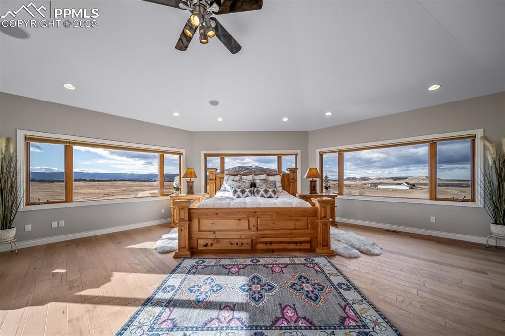 4586 East Best Road Larkspur, CO 80118 - Photo 21 of 50 Bedroom featuring a ceiling fan, recessed lighting, light wood-type flooring, and a mountain view