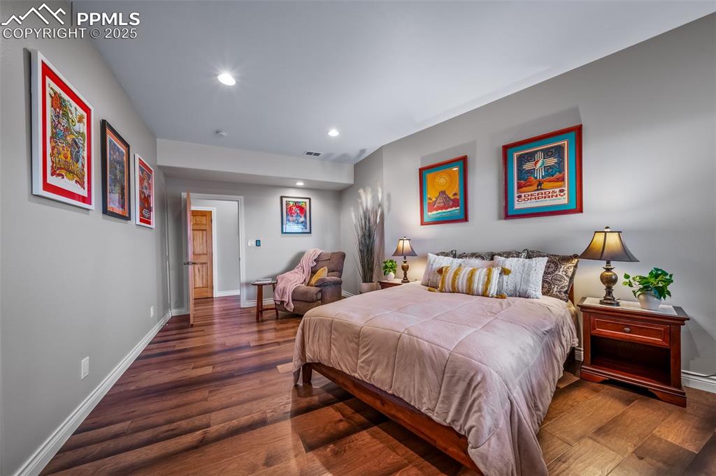 4586 East Best Road Larkspur, CO 80118 - Photo 33 of 50 Bedroom with dark wood-style floors and recessed lighting