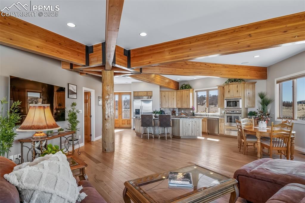 4586 East Best Road Larkspur, CO 80118 - Photo 8 of 50 Living area featuring beamed ceiling, light wood-type flooring, and recessed lighting