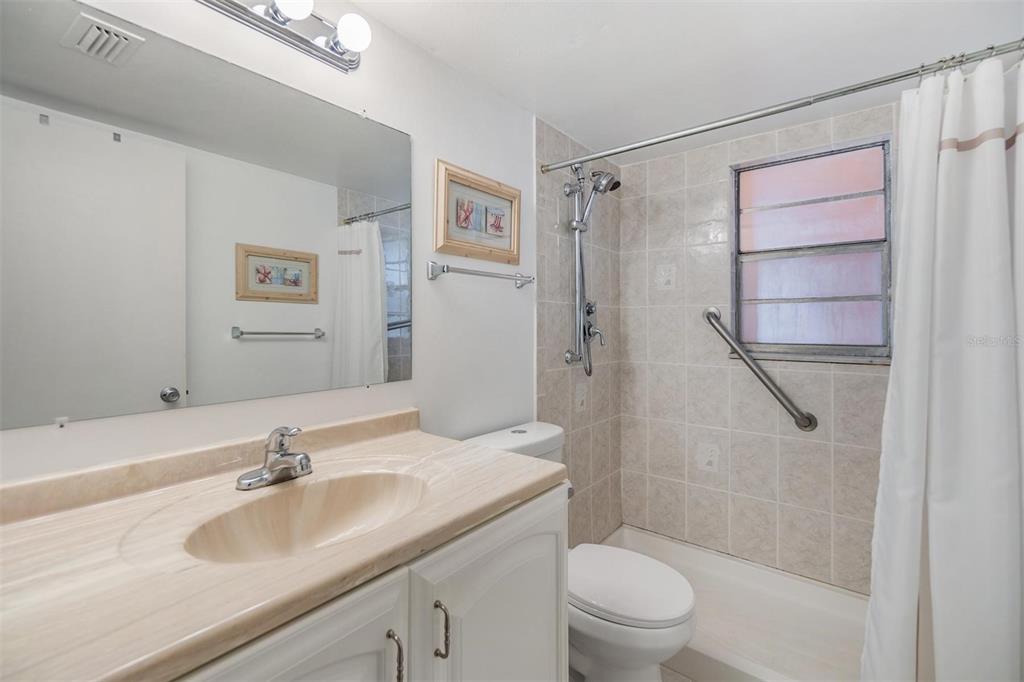 12760 Indian Rocks Road, Unit 104 Largo, FL 33774 - Photo 21 of 37 a bathroom with a sink toilet and shower