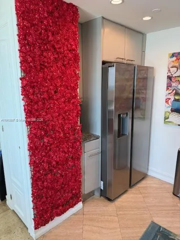 a kitchen with stainless steel appliances granite countertop a refrigerator and a counter space