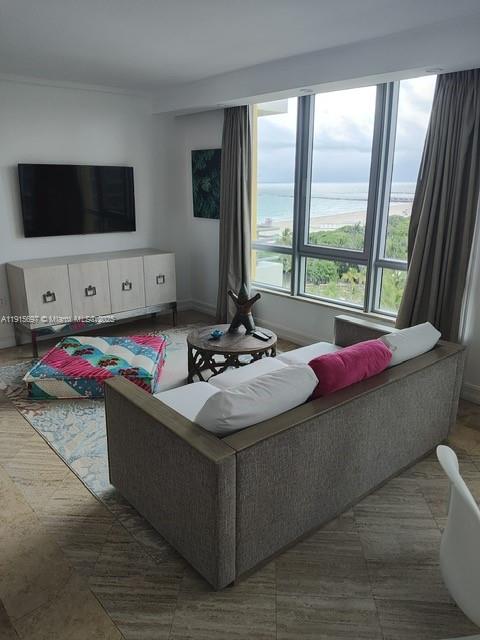 101 Ocean Drive, Unit 906 Miami Beach, FL 33139 - Photo 23 of 35 a living room with furniture and a flat screen tv