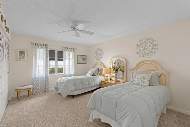 a bedroom with two beds and painting on the wall