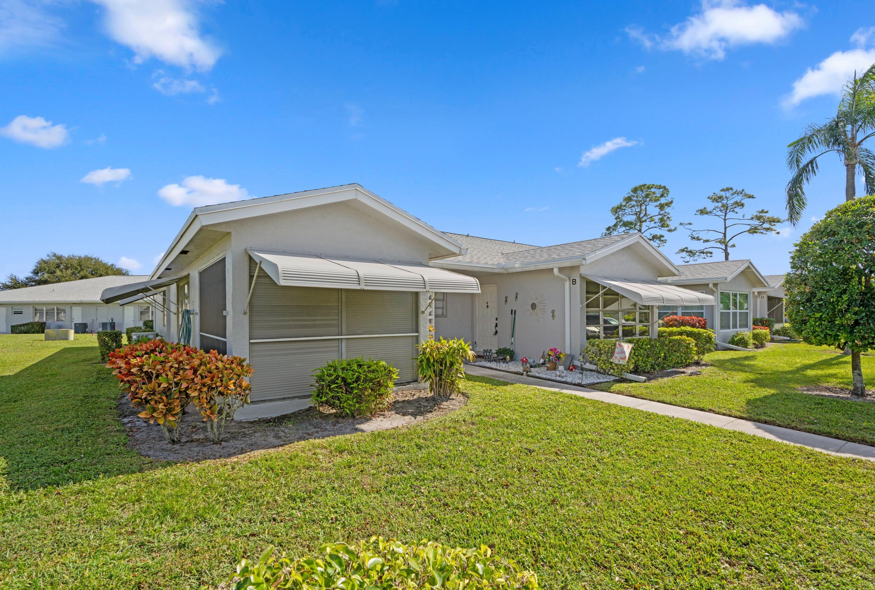 14609 Canalview Drive, Unit 231A Delray Beach, FL 33484 - Photo 14 of 33 a front view of a house with garden
