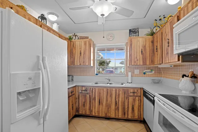 a kitchen with a sink cabinets and window