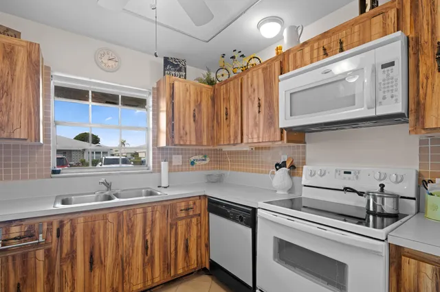 a kitchen with a sink cabinets and window