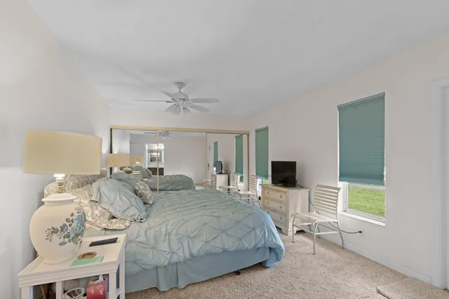 a spacious bedroom with a bed and flat screen tv