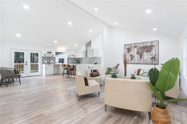 a living room with furniture a wooden floor and a painting on the wall