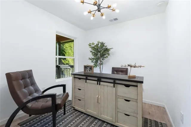 a view of a workspace with furniture and a potted plant