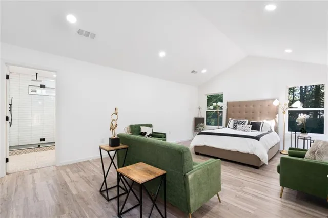 a view of a bedroom with furniture and wooden floor
