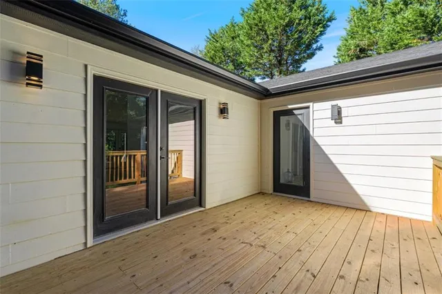 a view of a hallway with wooden floor and entryway