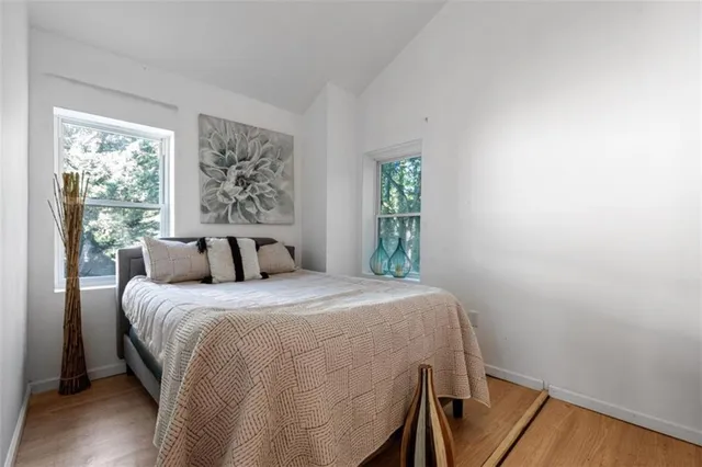 a bed sitting in a bedroom next to a window