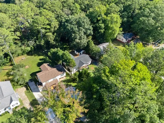 an aerial view of a house with yard