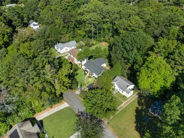 an aerial view of a house with a yard