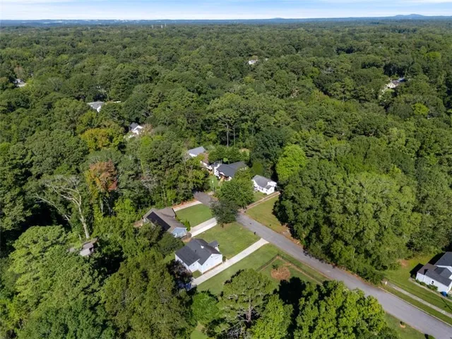 an aerial view of a house with a yard