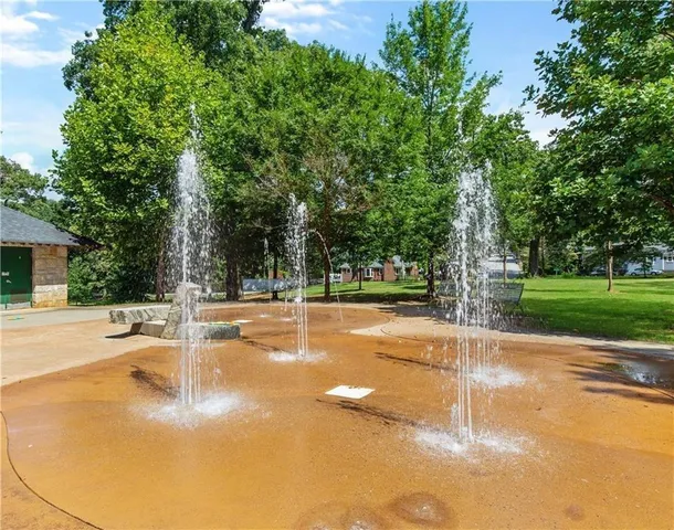 a view of a street with large trees