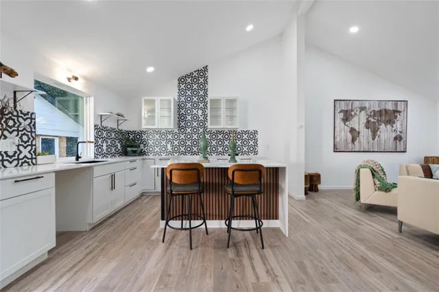 a kitchen with granite countertop white cabinets and white appliances