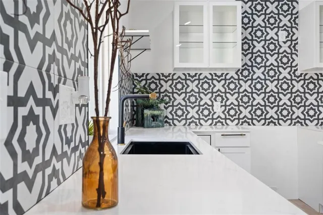 a view of a sink and dishwasher with wooden floor