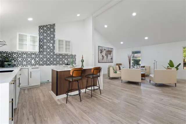 a living room with furniture dining table and wooden floor