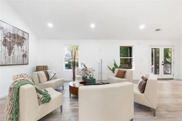a living room with furniture and wooden floor