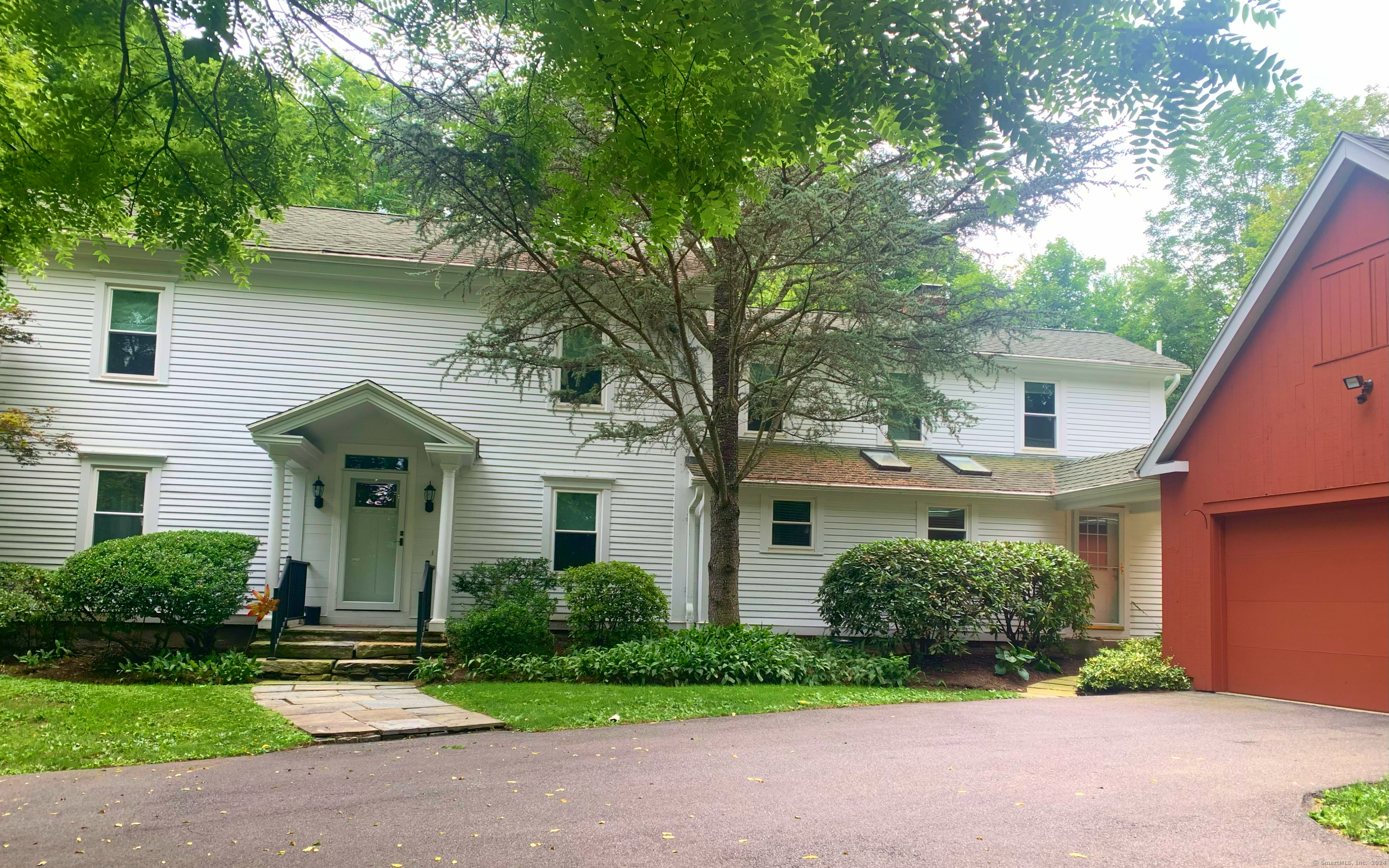 74 Sullivan Road, Unit 123 New Milford, CT 06776 - Photo 1 of 1 a front view of a house with a yard and potted plants