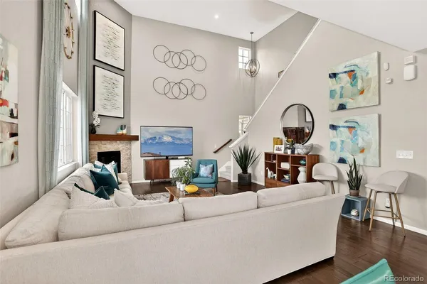 a living room with fireplace furniture and a window