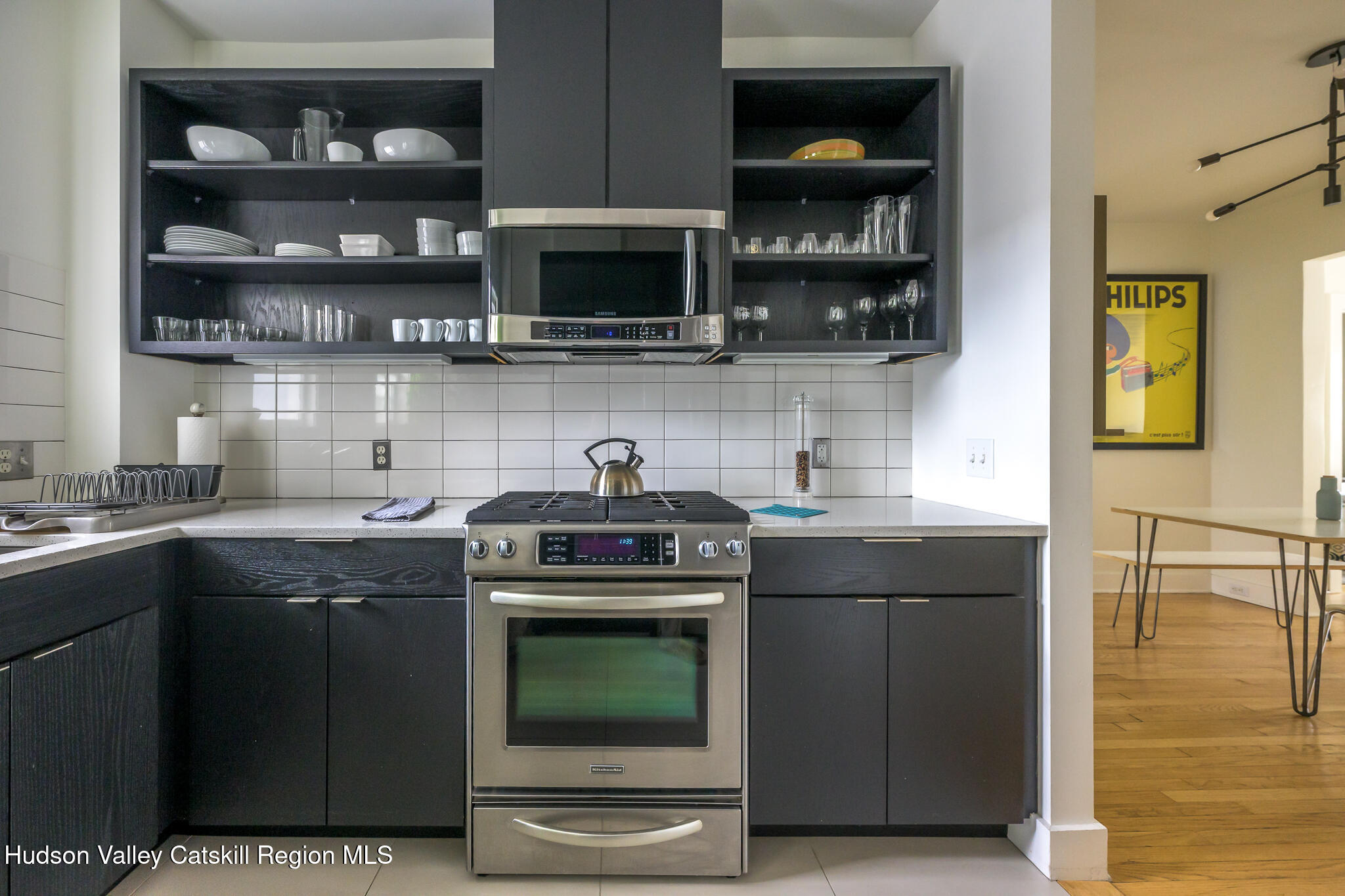 705 Warren Street Hudson, NY 12534 - Photo 17 of 40 a kitchen with stainless steel appliances granite countertop a stove and a microwave