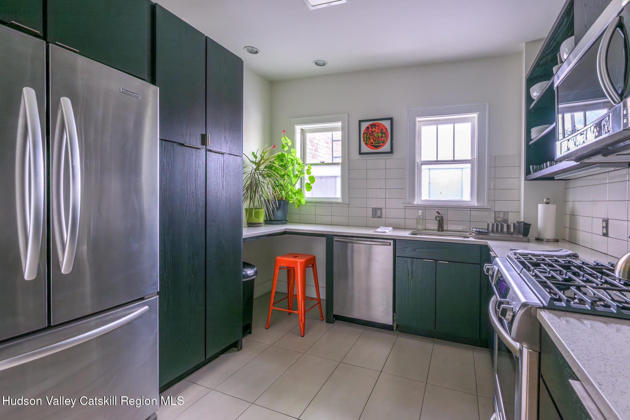 705 Warren Street Hudson, NY 12534 - Photo 18 of 40 a kitchen with stainless steel appliances granite countertop a refrigerator and a sink