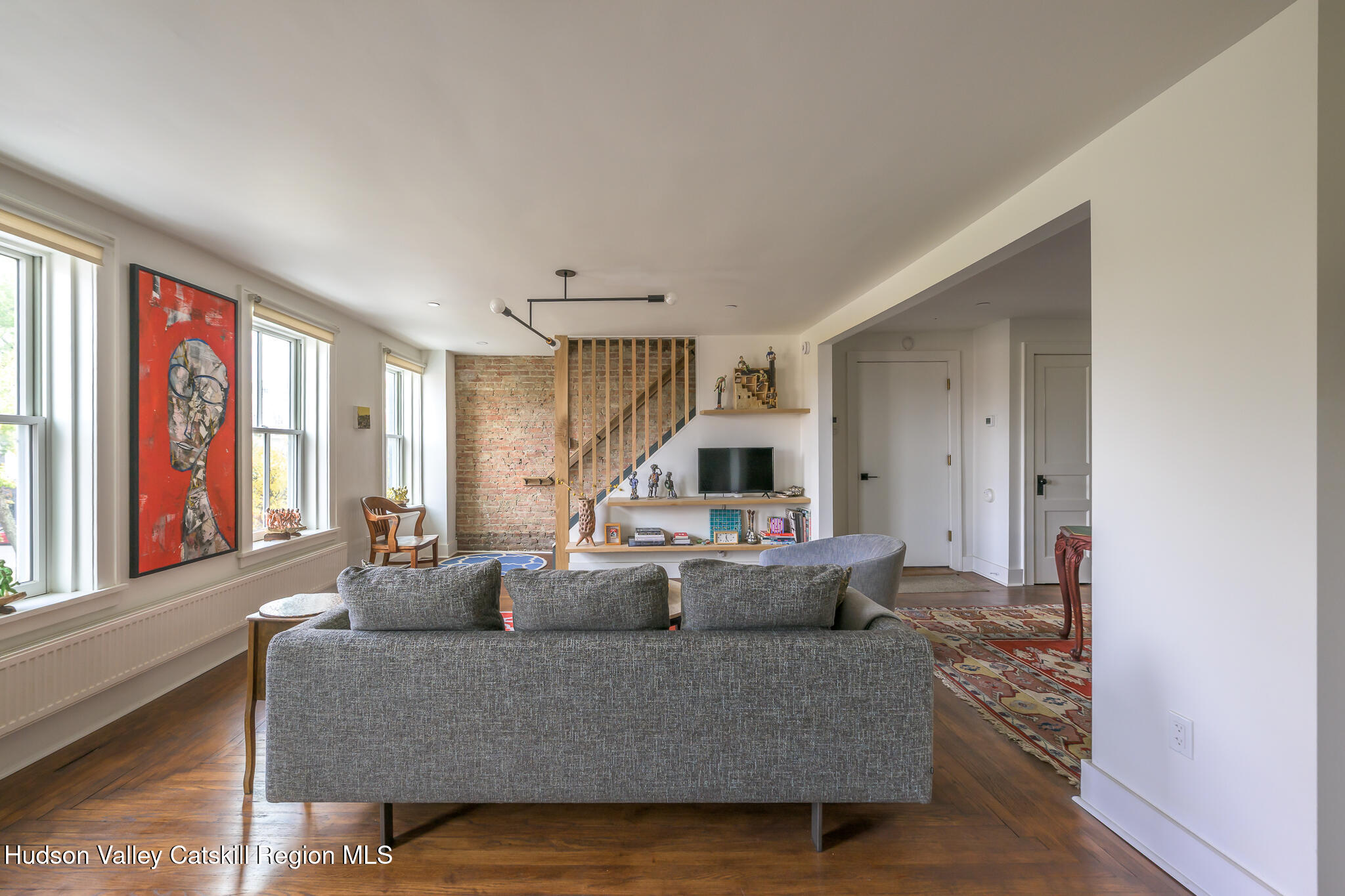 705 Warren Street Hudson, NY 12534 - Photo 24 of 40 a living room with furniture and a large window