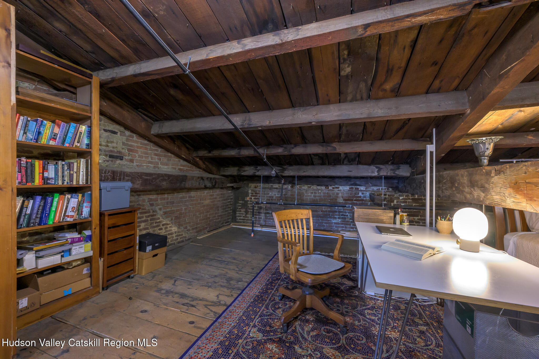 705 Warren Street Hudson, NY 12534 - Photo 34 of 40 a dining room with furniture and a book shelf