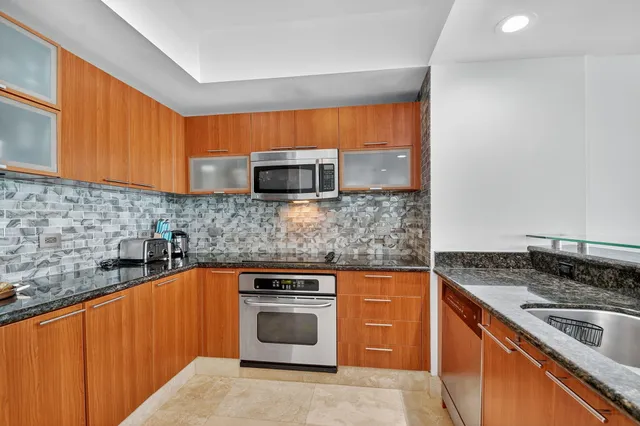 a bedroom with a couch chair and a floor to ceiling window