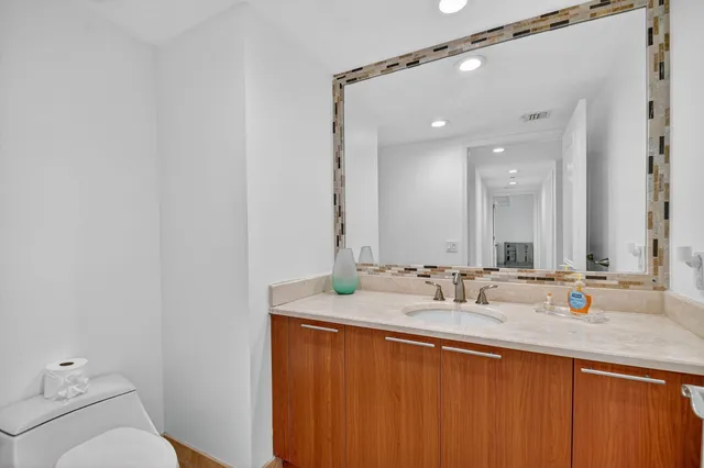 a view of a swimming pool with a bench and trees in the background