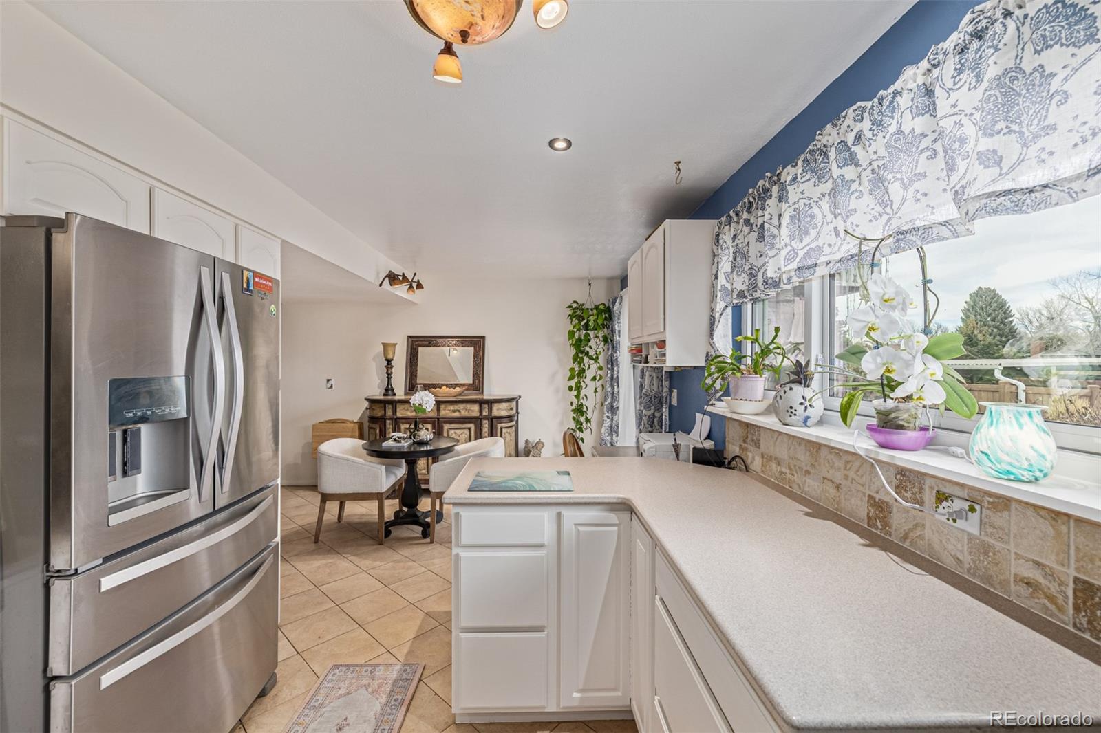 4233 East Maplewood Way Centennial, CO 80121 - Photo 13 of 50 a kitchen with stainless steel appliances a refrigerator and a stove