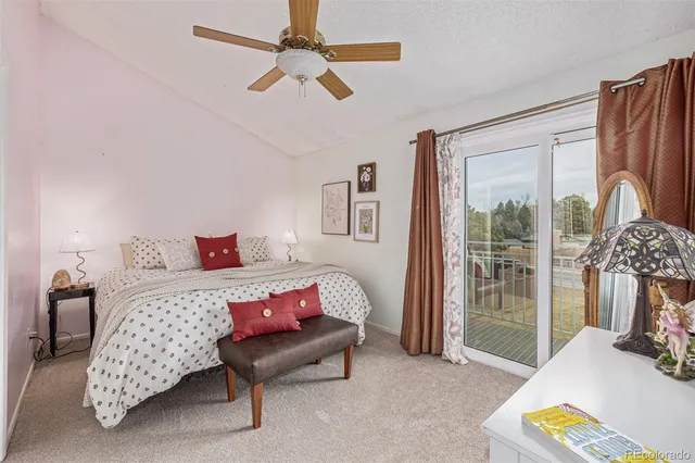 a bedroom with furniture and a large window