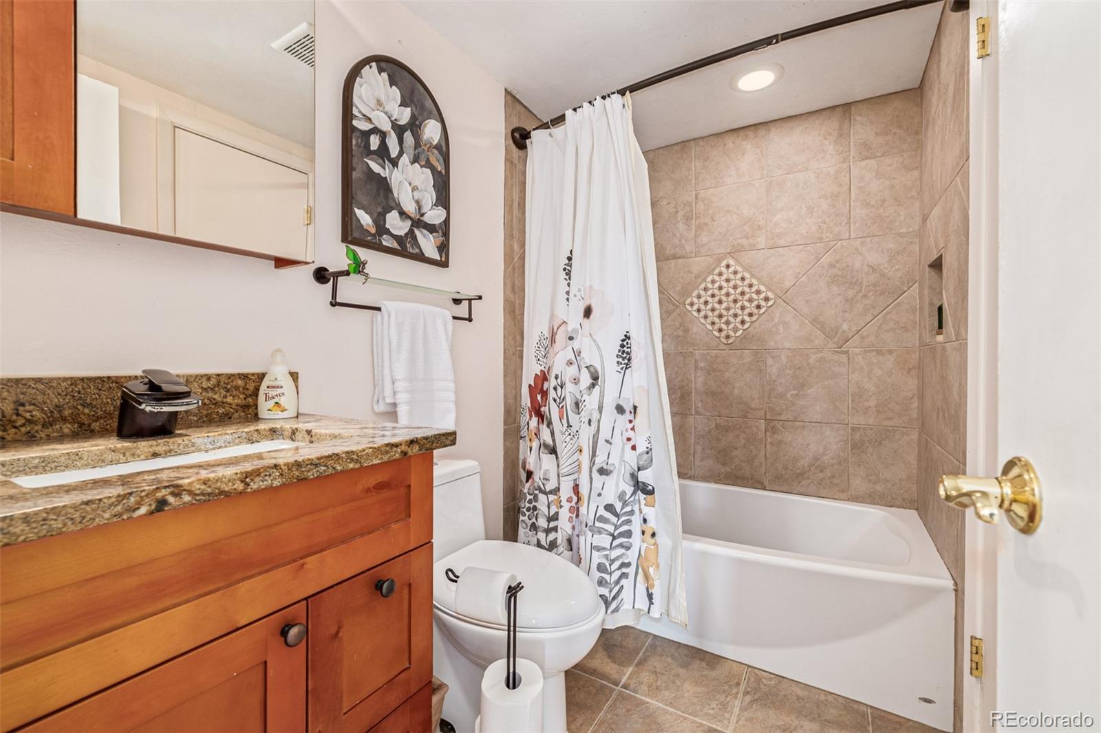 4233 East Maplewood Way Centennial, CO 80121 - Photo 22 of 50 a bathroom with a granite countertop sink a toilet and bathtub