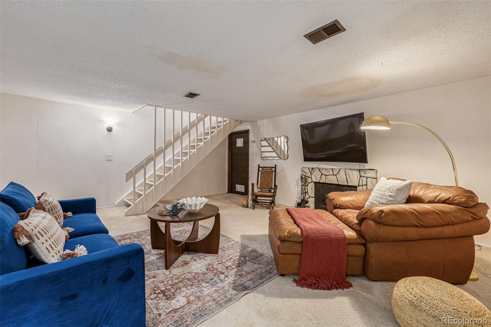4233 East Maplewood Way Centennial, CO 80121 - Photo 28 of 50 a living room with furniture and a flat screen tv
