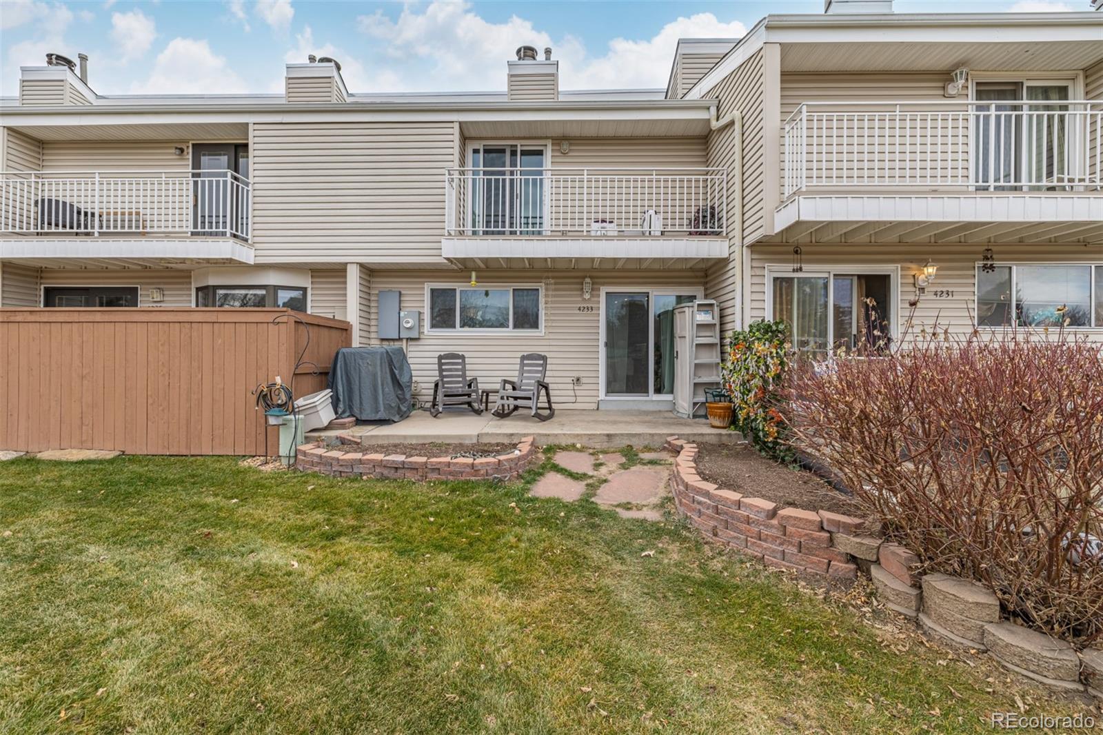 4233 East Maplewood Way Centennial, CO 80121 - Photo 33 of 50 a view of a house with backyard and sitting area