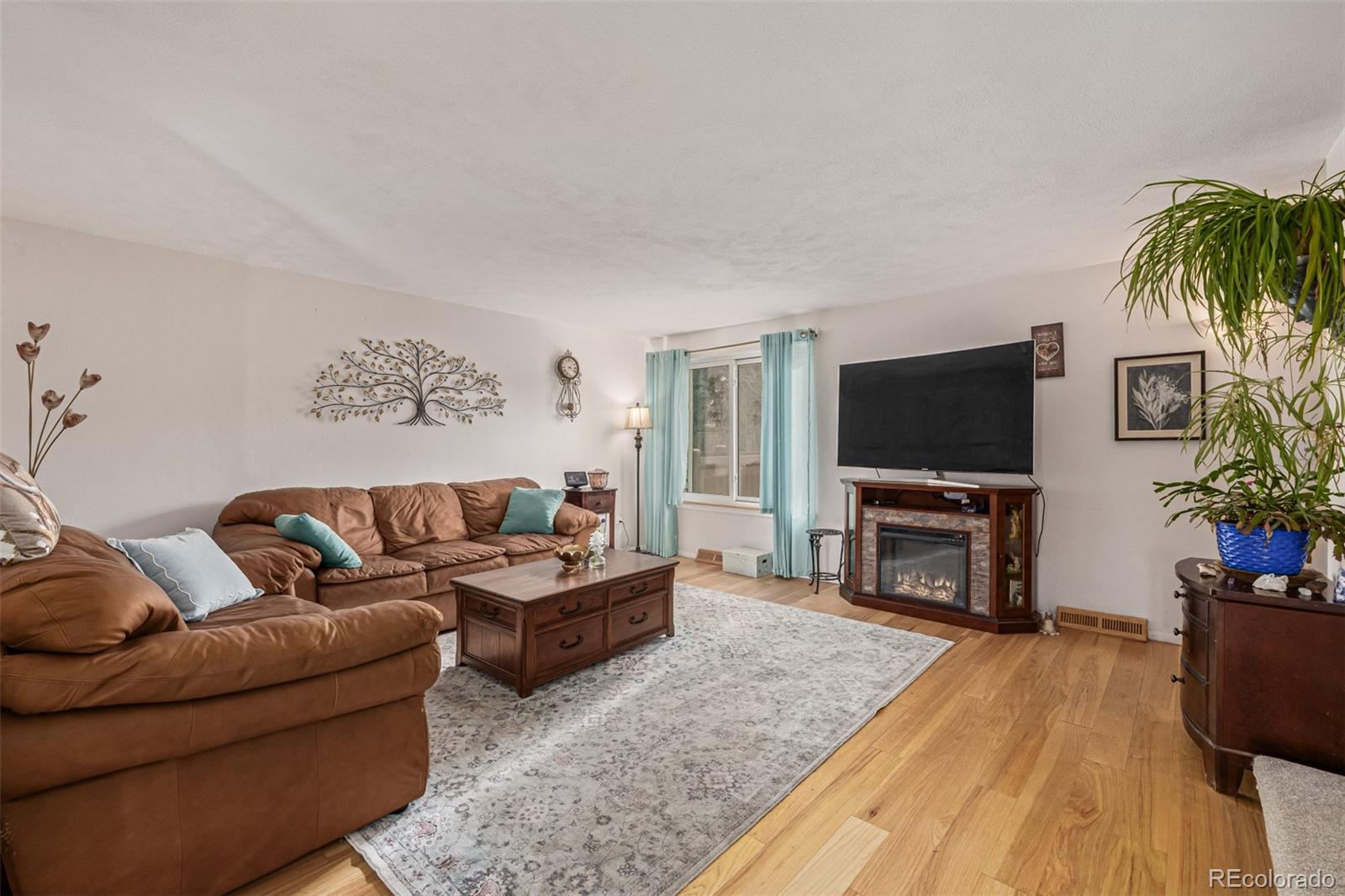 4233 East Maplewood Way Centennial, CO 80121 - Photo 4 of 50 a living room with furniture and a flat screen tv
