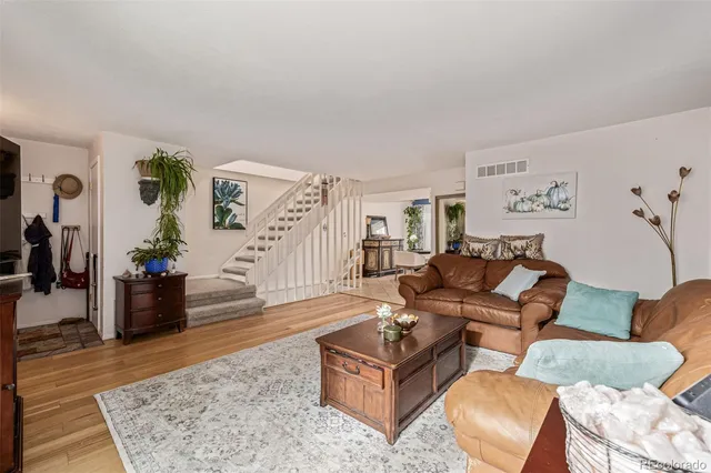 a living room with furniture rug and wooden floor
