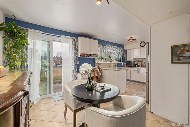 a kitchen with a table and chairs