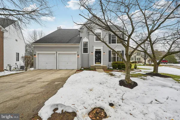 a view of a white house with a yard covered in snow