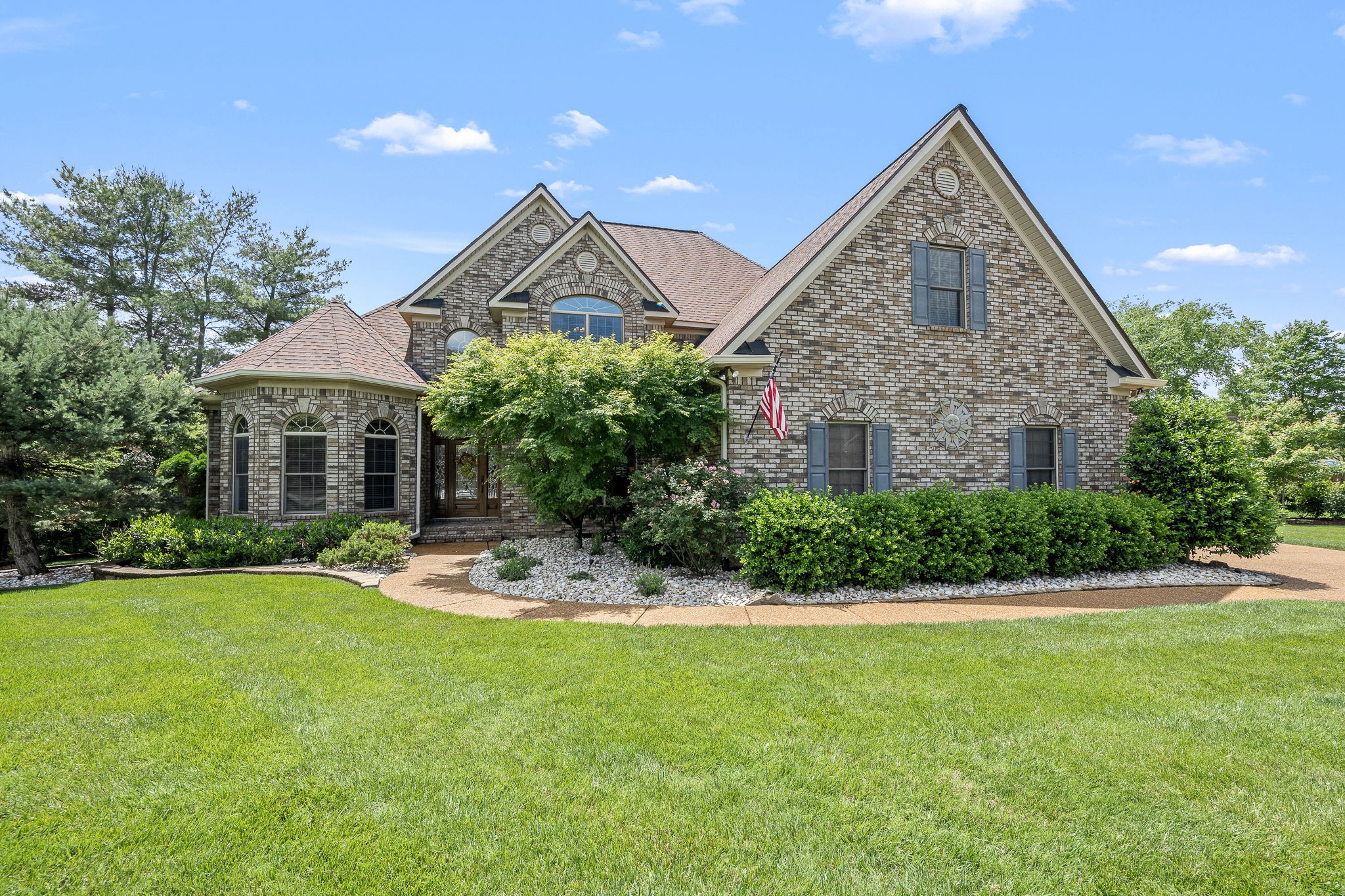 a front view of a house with a yard and garage