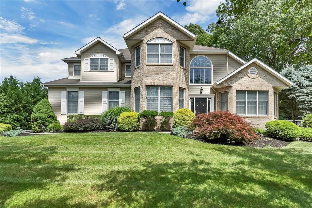 a front view of a house with a yard and porch