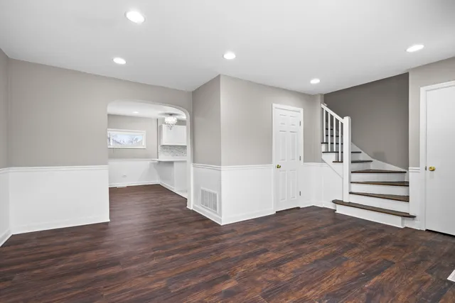 a view of entryway with wooden floor and stairs
