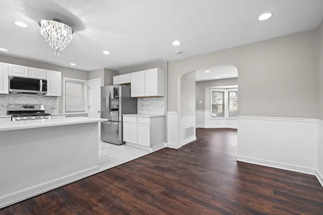 a kitchen with stainless steel appliances granite countertop a refrigerator and microwave