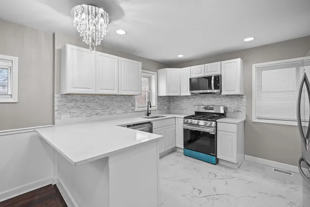 a kitchen with a sink a stove a microwave and cabinets