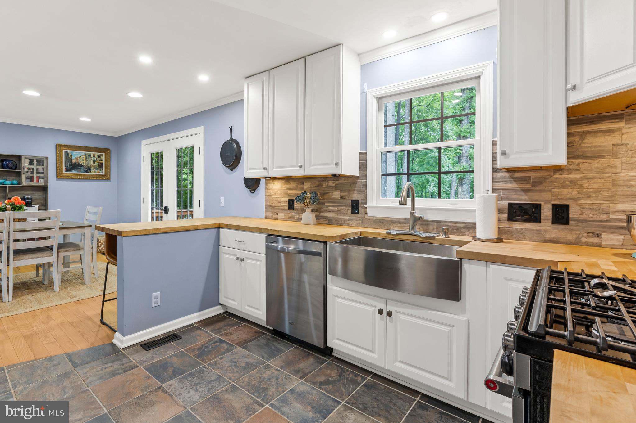 1425 Jacks Shop Road Rochelle, VA 22738 - Photo 20 of 56 a kitchen with stainless steel appliances granite countertop a stove a sink and a refrigerator