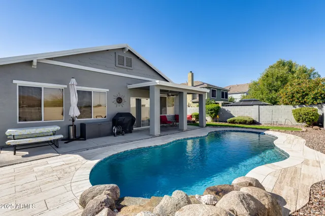 a view of a house with swimming pool and sitting area
