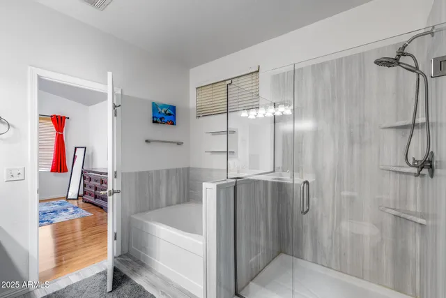 a bathroom with a tub and shower